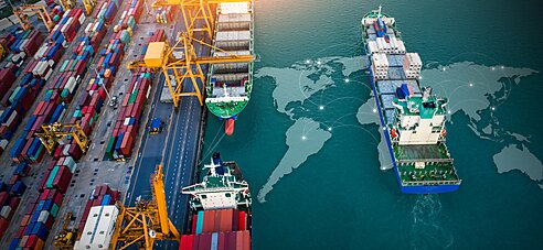 A cargo ship imposed over a world map