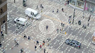 Computer code overlapping people walking in the street